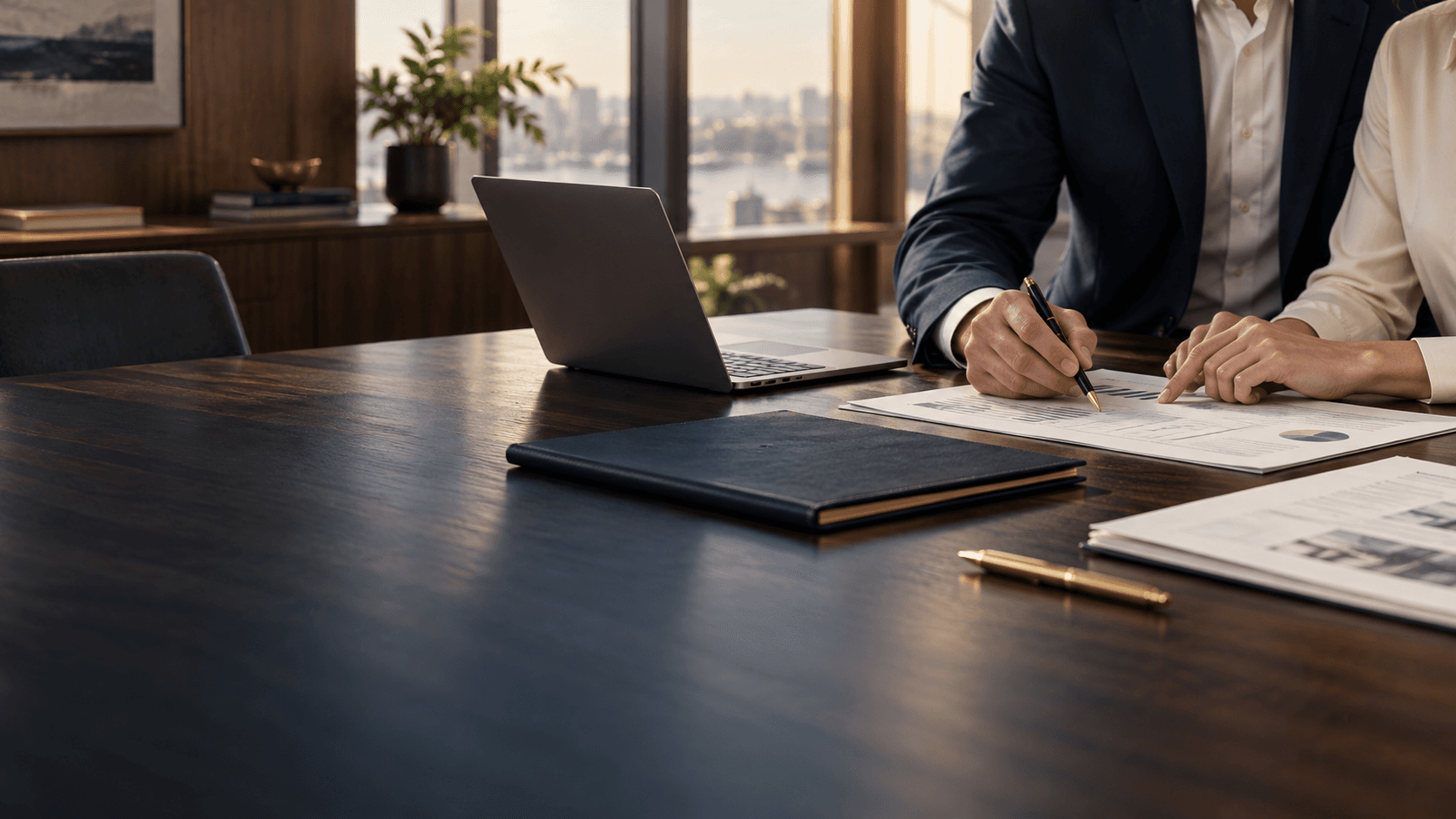 Accounting consultation with financial records at a walnut desk